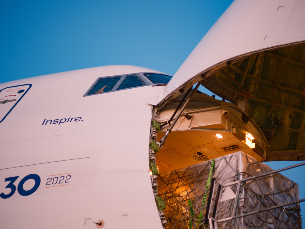 Open cargo door of large freighter aircraft during loading operations. 
